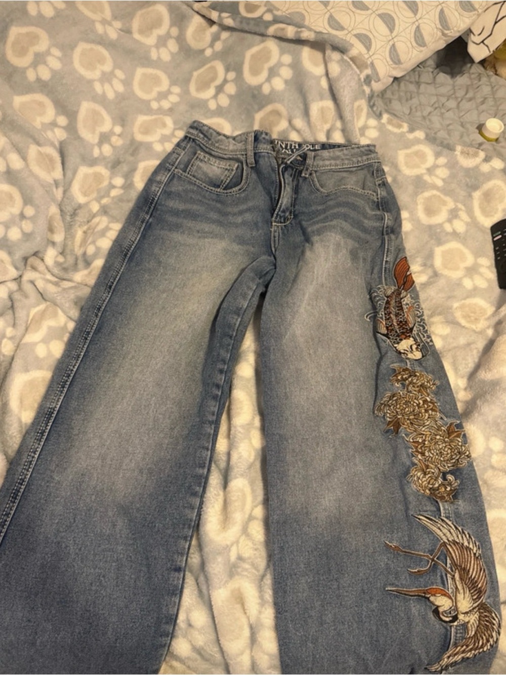 Zumiez Light Blue Straight Leg Jeans with Embroidered Bird Detail
